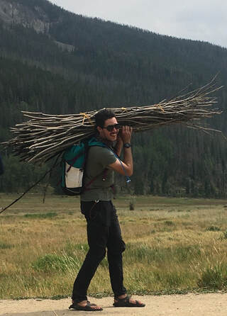 Mike Greisiger carries willow stakes for planting